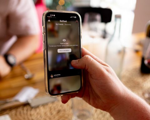 a person holding a cell phone in their hand