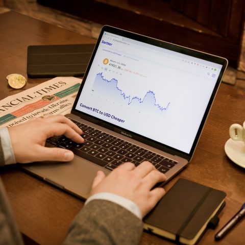 a person typing on a laptop on a table