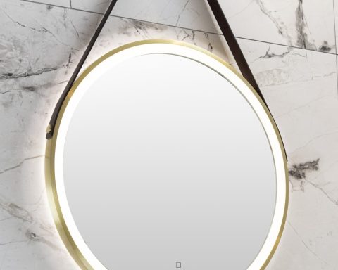 a round mirror hanging on the wall above a sink