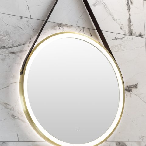 a round mirror hanging on the wall above a sink